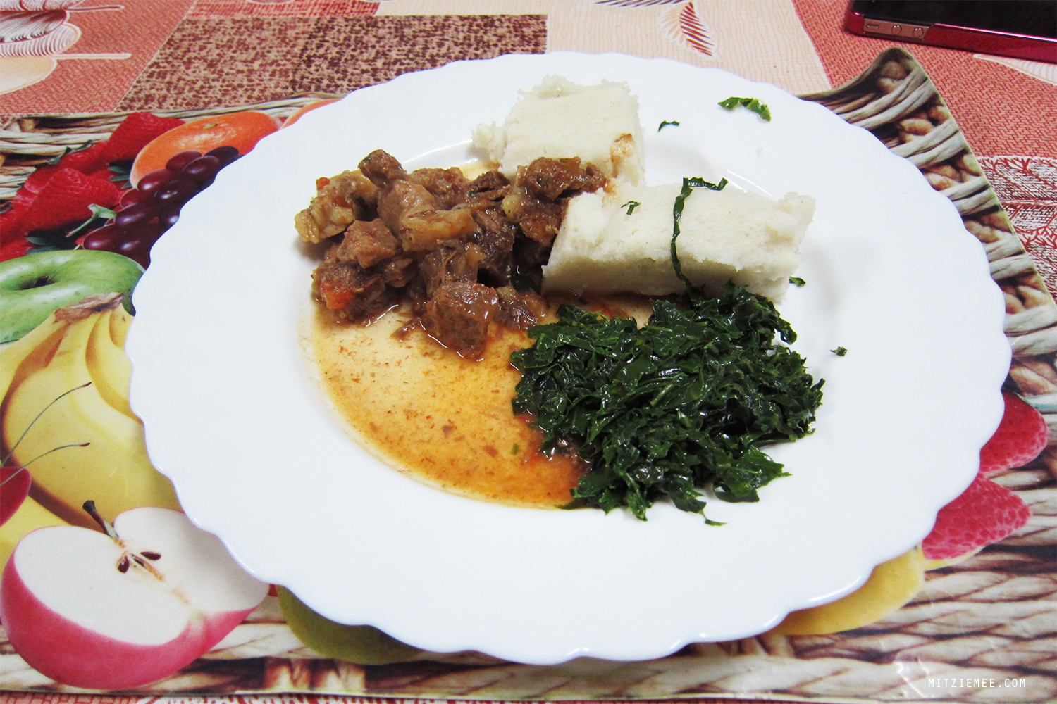 Stew with ugali (made from maize flour) and sukuma wiki (spinach)